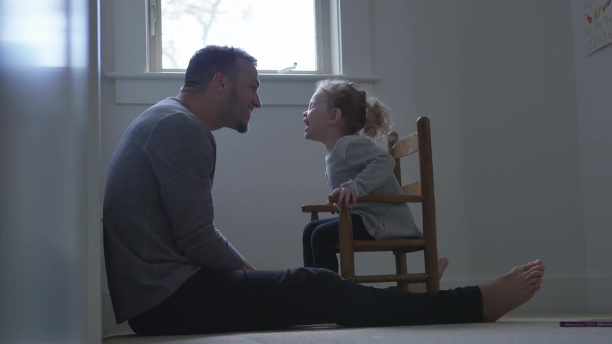 Child laughs with man