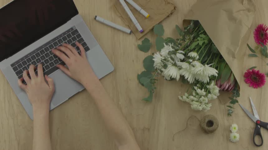 A woman typing on a laptop