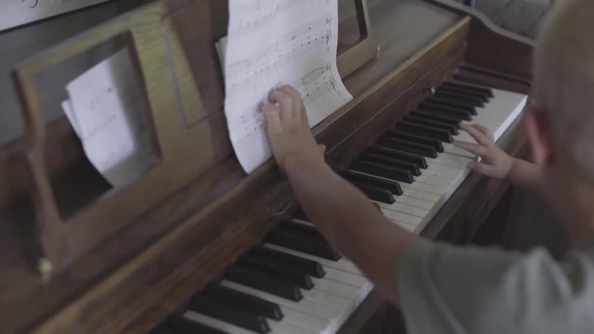 Family Playing Old Piano In House