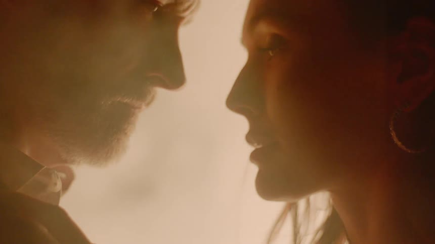 A woman and man are looking at each other