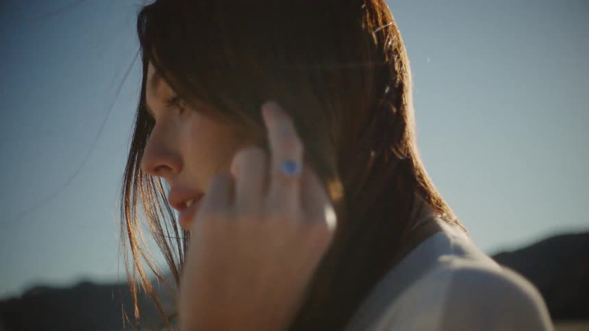 A woman stares silently at the ground