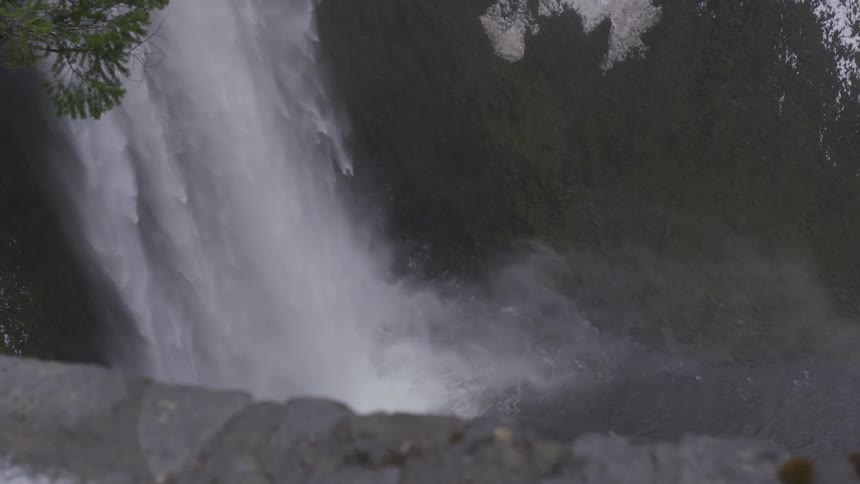 Large waterfall flows into river