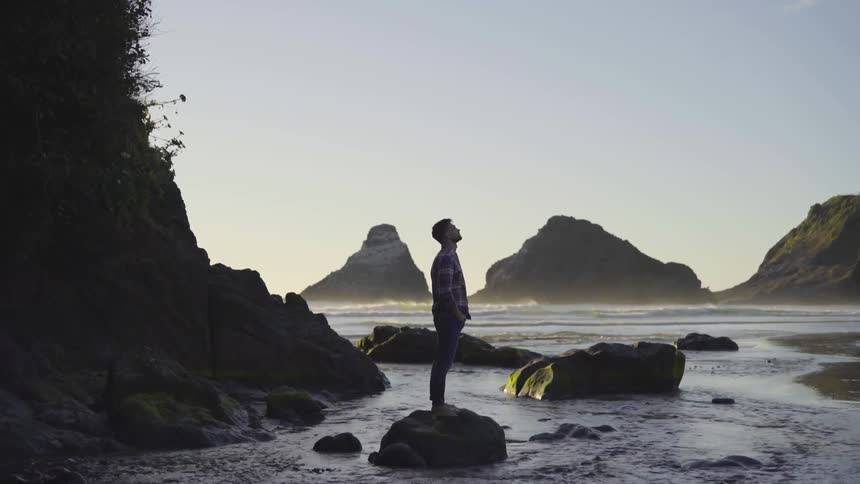 Man standing on some rocks in a river