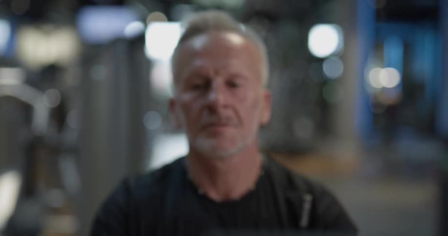 A man is using a gym rowing machine
