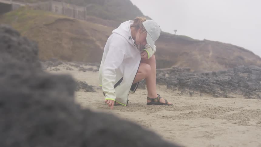 Girl At A Beach On A Cloudy Day