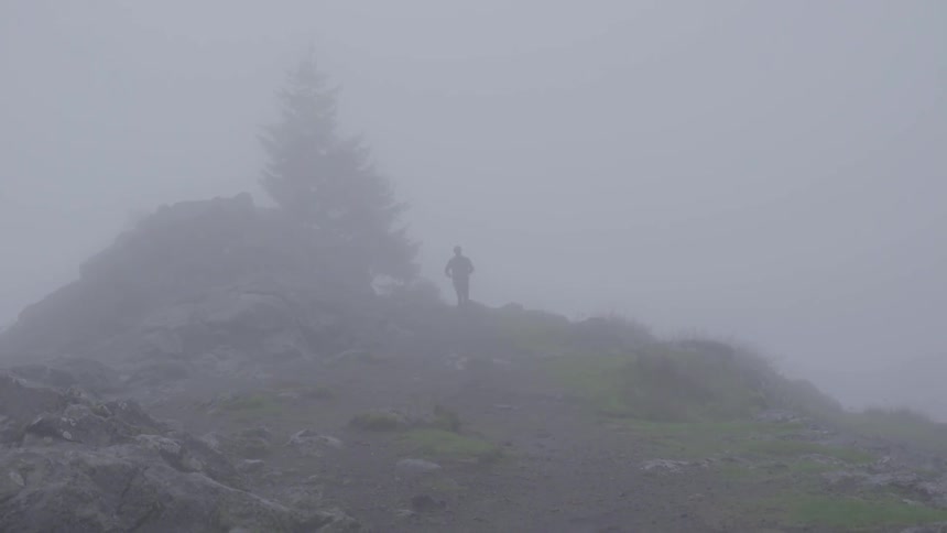 Man jogging up a very foggy path