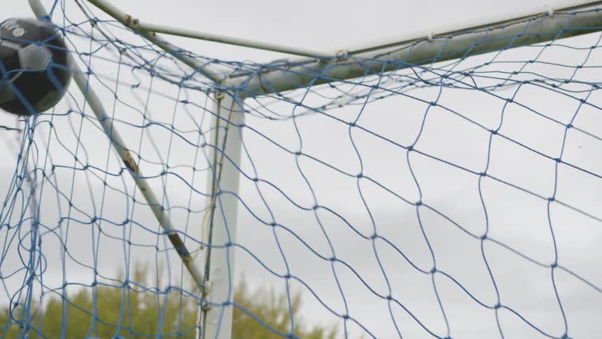 Soccer ball going into a net