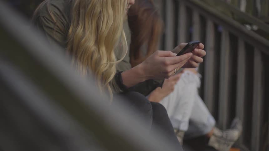 Friends On Their Phones And Taking Selfies