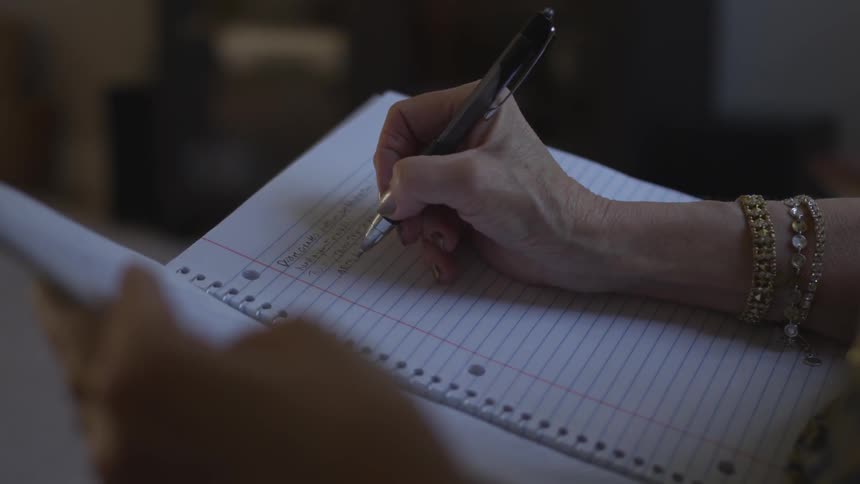Woman writing on a notebook