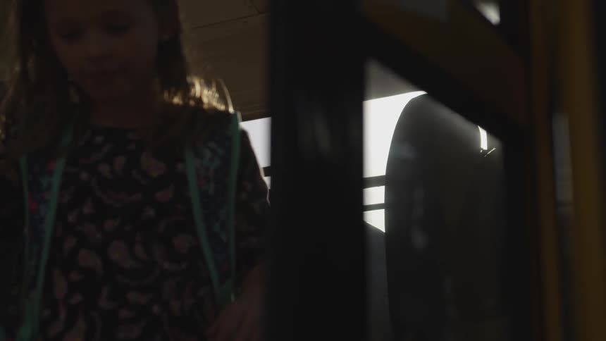 Kids rush to get off of a bus