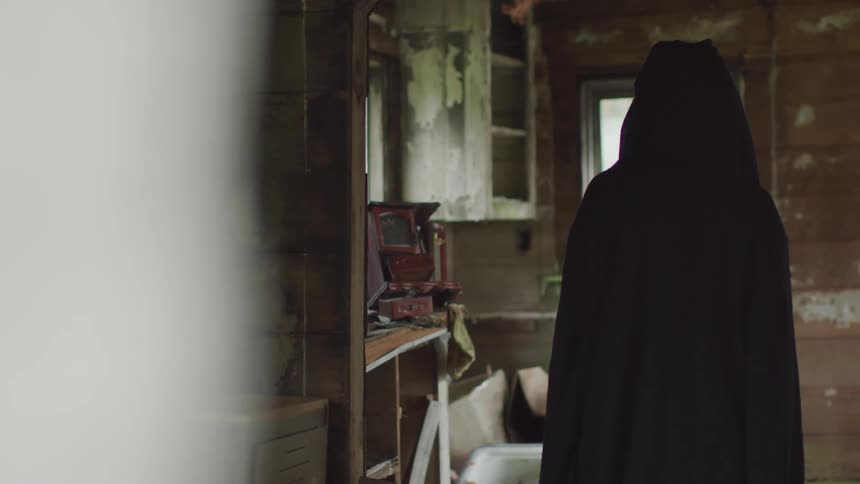 Hooded Figure In Abandoned House