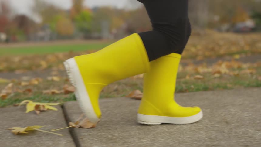 A person running in yellow boots