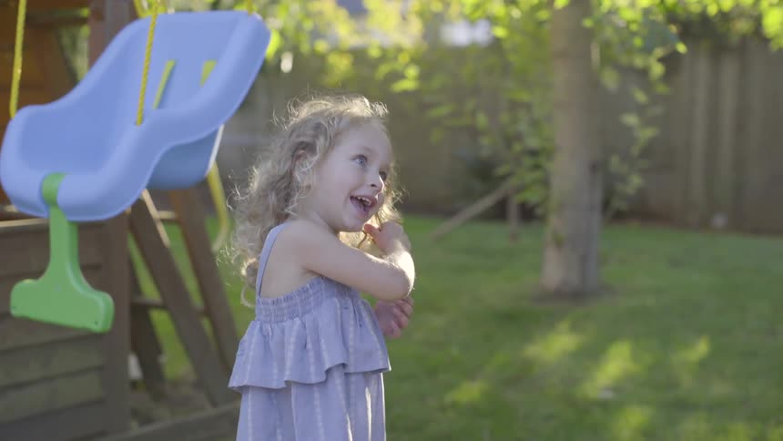 A girl playing in the backyard