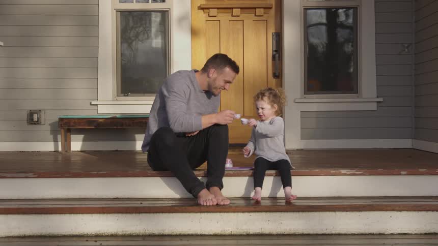 Father And Daughter Playing At Home