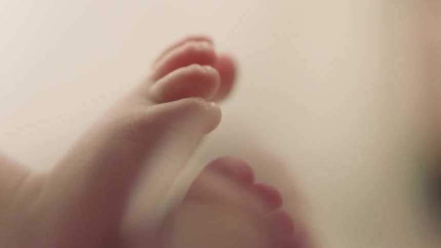 A baby wiggles its feet