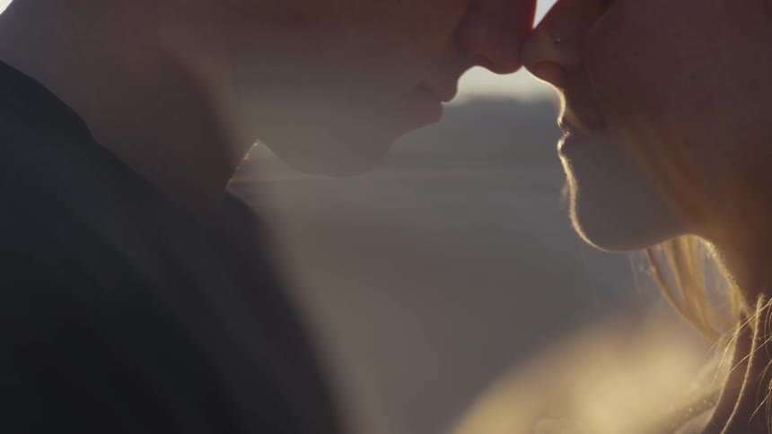 A man and woman touching faces