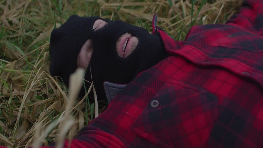 Man with mask laying on the ground