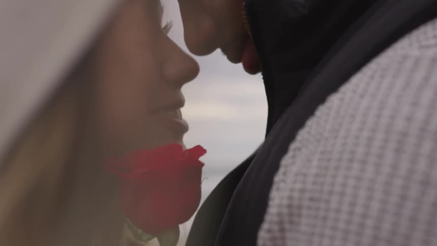 A man and a  woman face each other during a tender moment