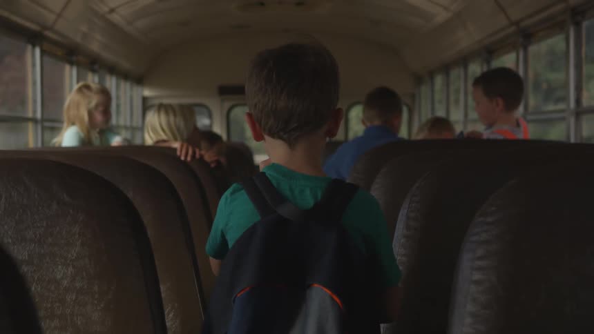 Boy walking through a bus