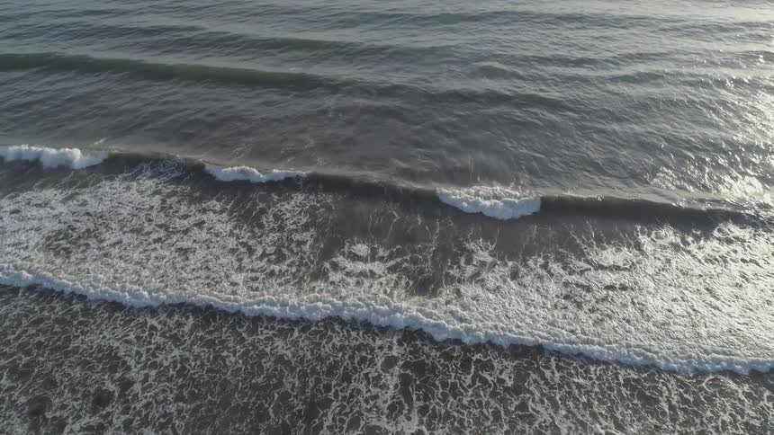 Ocean waves lap at the beach