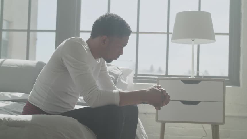 Man sitting on a bed