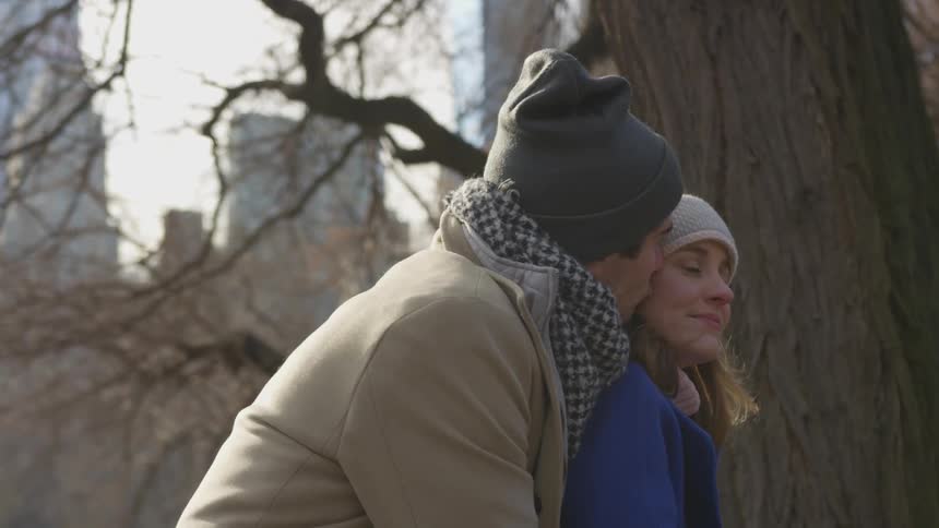 A man kisses a woman on the cheek