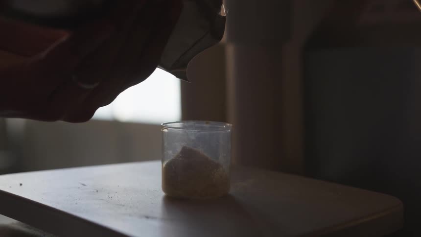 Flour is being poured into a cup