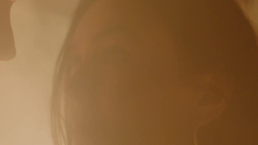 A man and woman stare at each other through the smoke