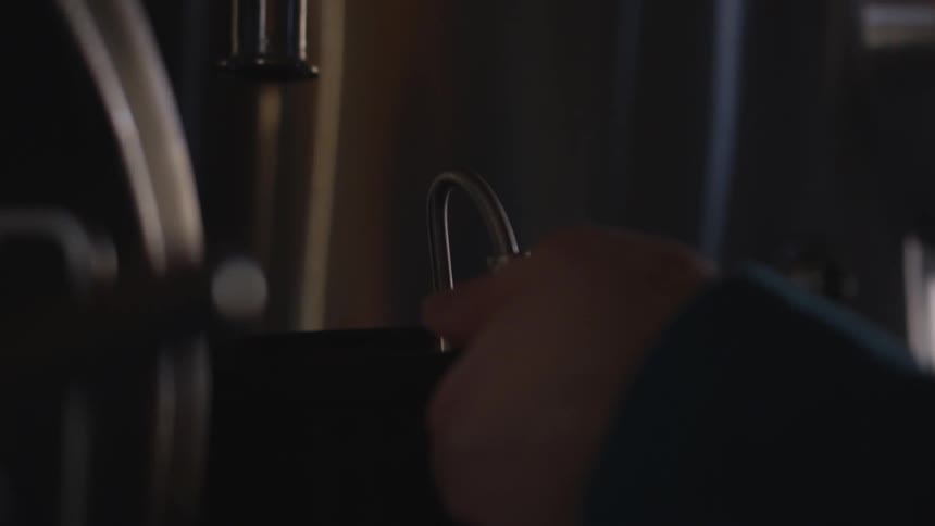 Person makes coffee at coffee machine