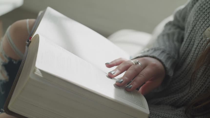 A woman skims through a book