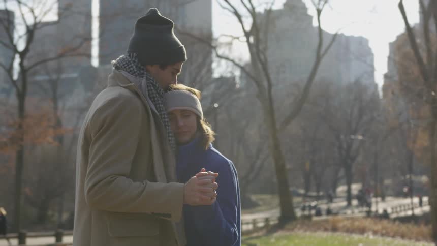 A man and woman holding each other outside