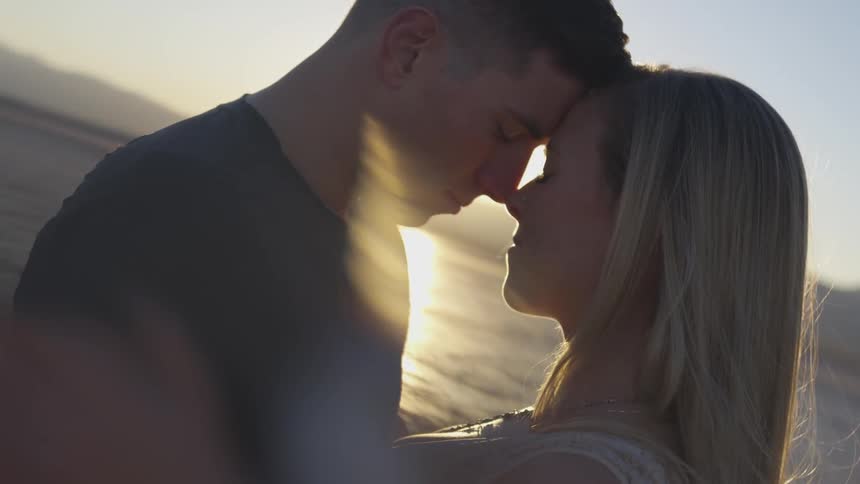 Couple holding each other at the beach