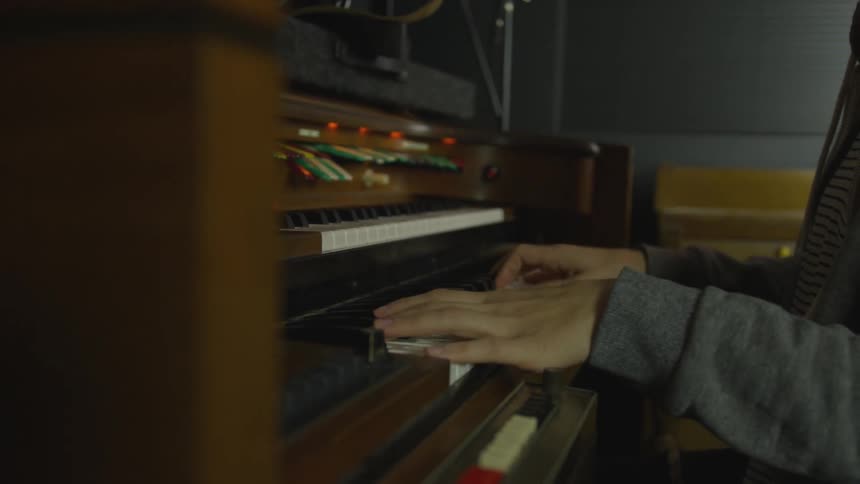 Person plays organ indoors