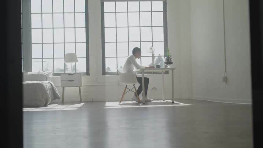 Man sits at table with laptop
