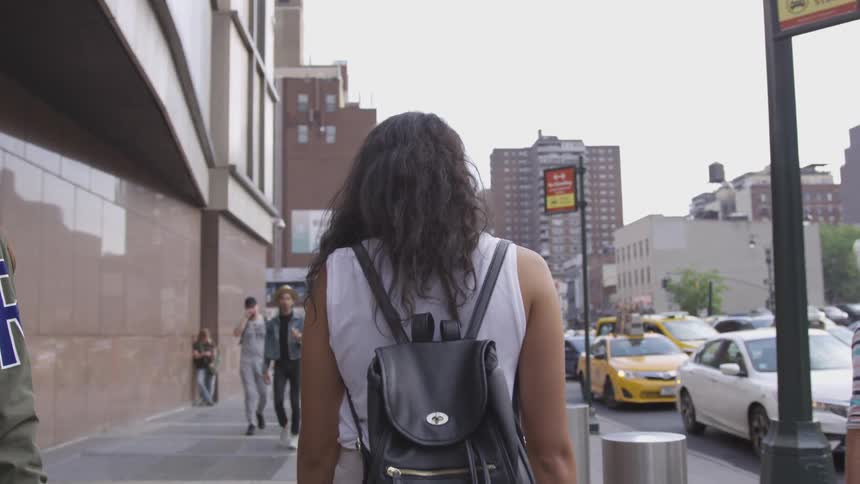 Two women walking down the sidewalk