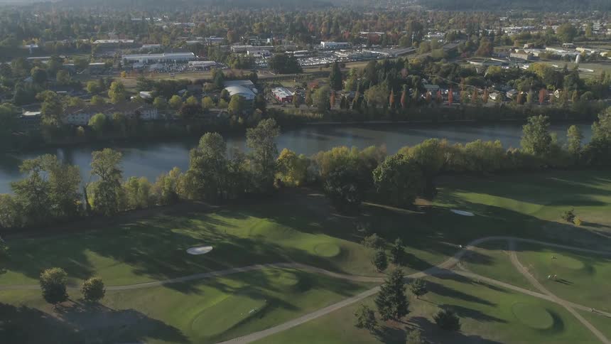 A nice looking golf course is next to a river
