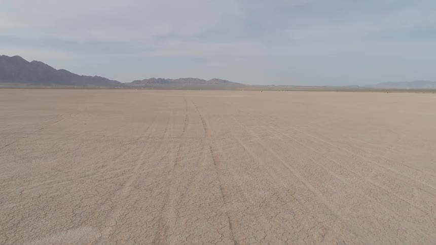 Flying over a dry lake bed in the middle of a valley
