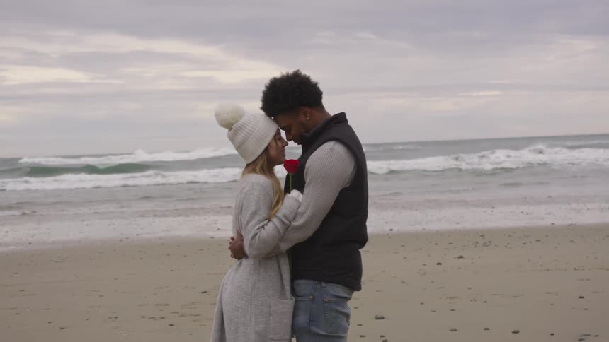 Man and woman hugging on a beach