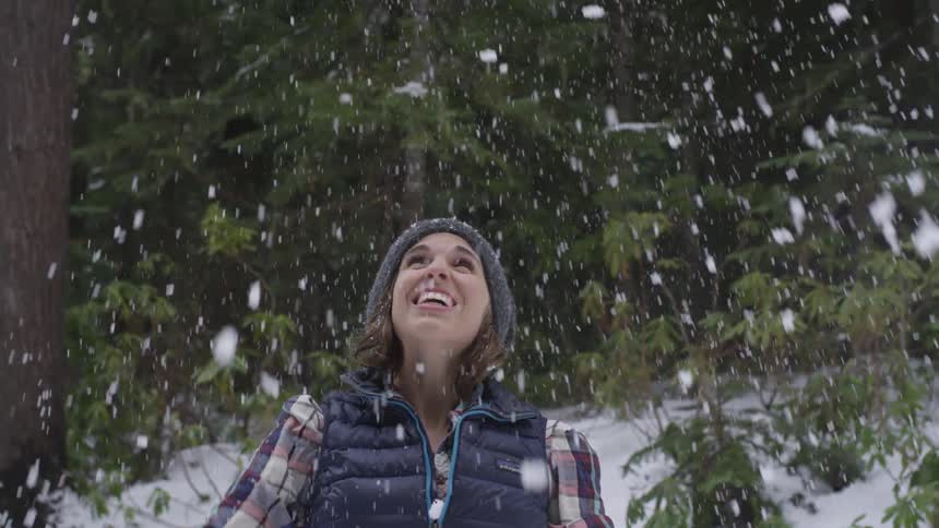 Rewind of woman throwing snow in air