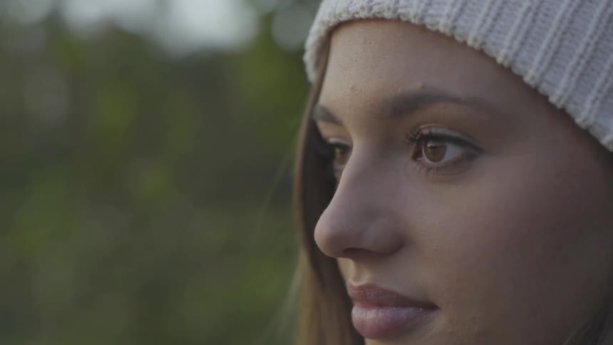 Young woman looks up and straight ahead