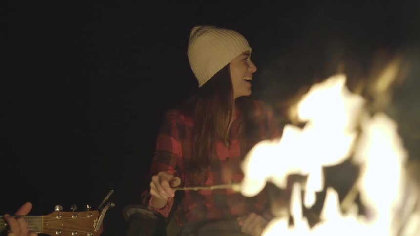 Friends Sitting Around A Campfire