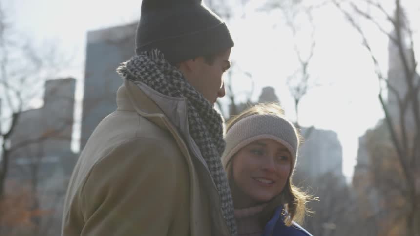 A man and woman hold hands and dance
