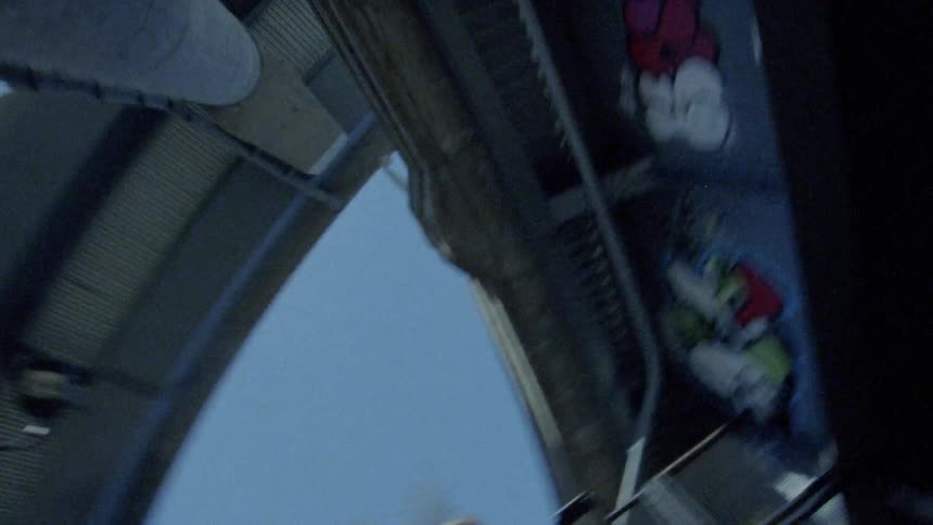 A tall overpass is covered in graffiti underneath