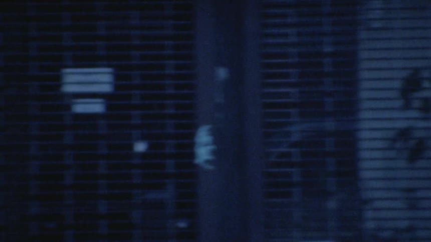 Looking at the reflection of a van driving down a street