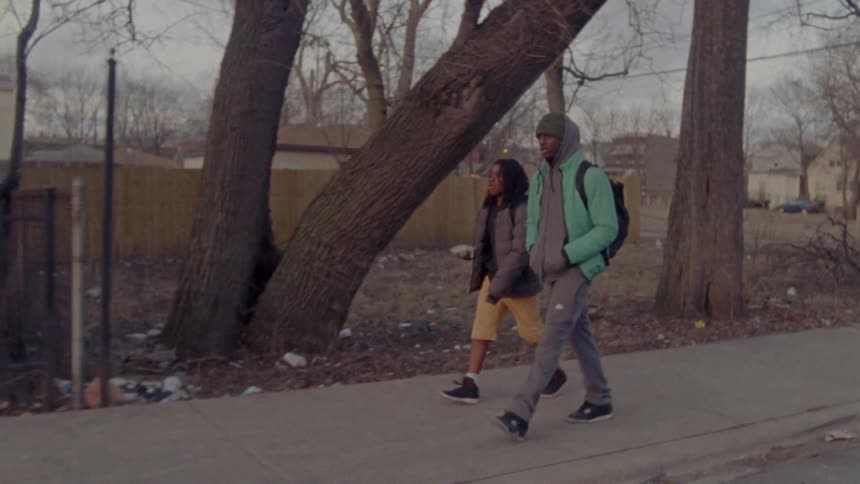 Man and woman walk on sidewalk in winter