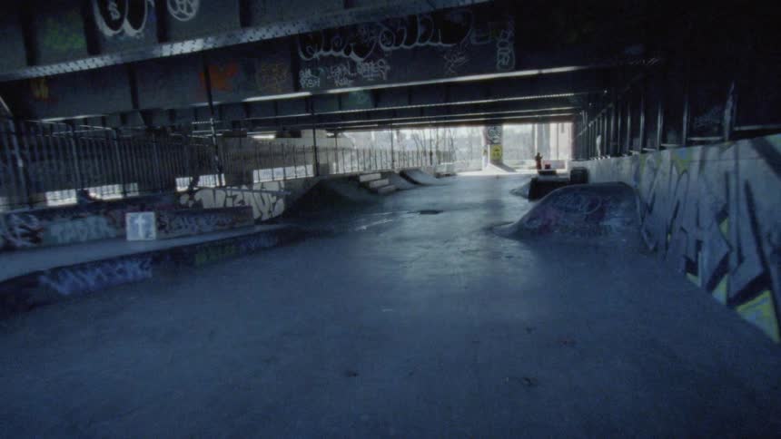 Looking at graffitis on a bridge underpass