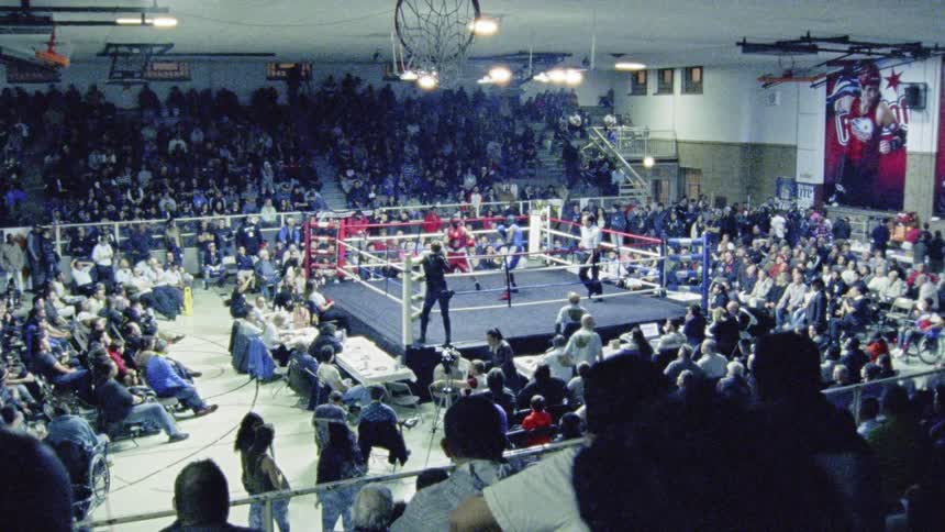 Boxers have a match as the crowd watches on