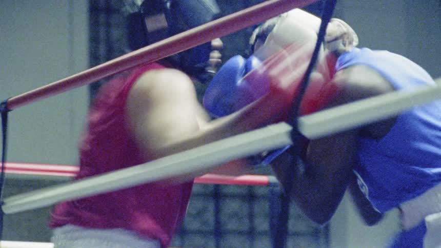 Two men are boxing inside a boxing ring