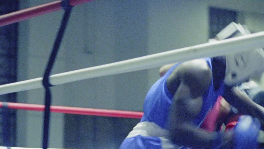 Two boxers spar in the ring