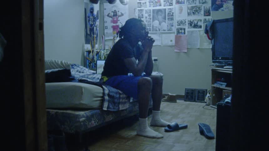 A man sitting on his bed